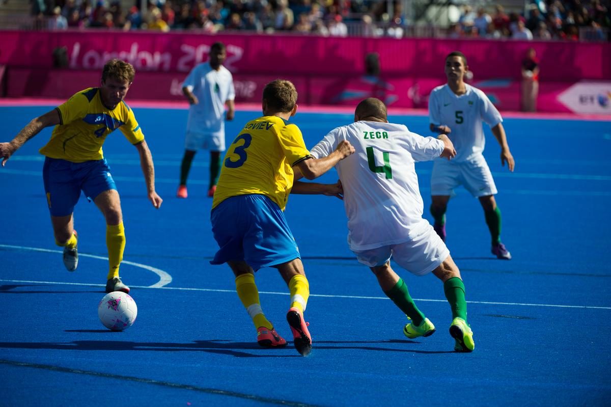 Football players on a blue field of play