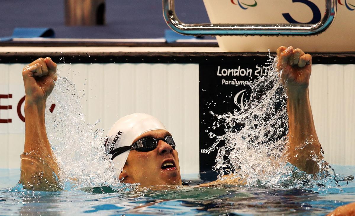 A swimmer clenches his fists in delight after winning gold at London 2012.