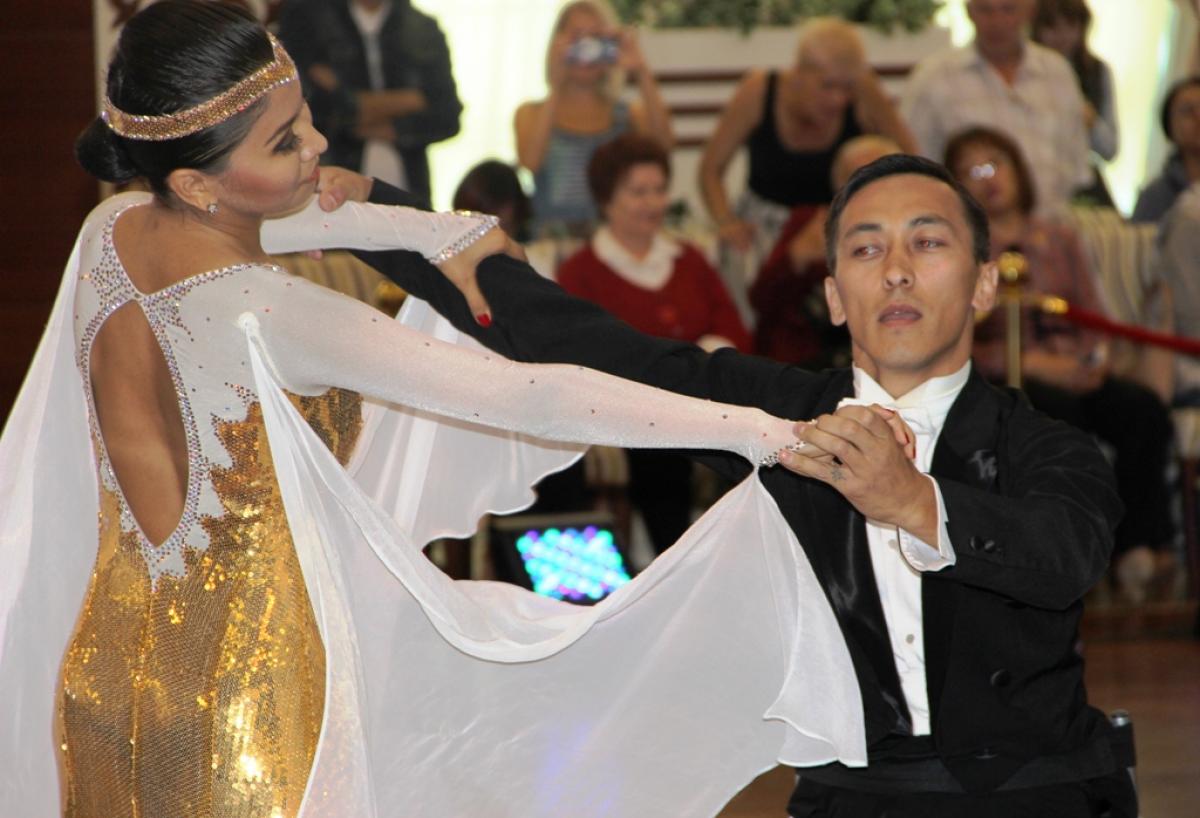 Two dancers, one in wheelchair, one standing pose