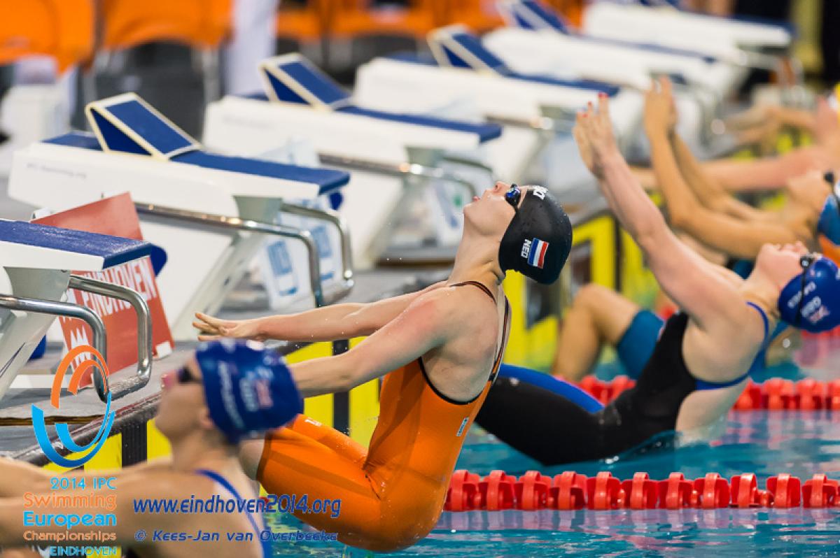 Swimmers start a backstroke race at the 2014 IPC Swimming European Championships.