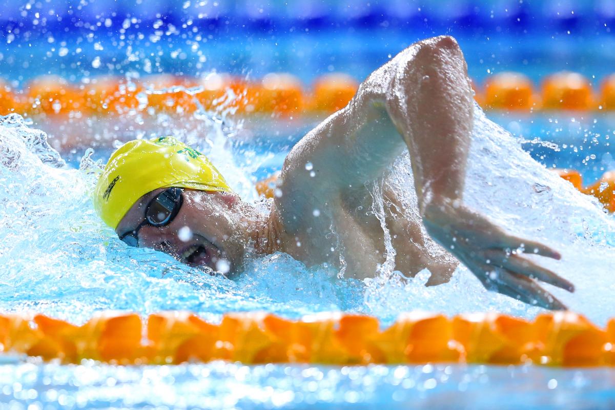 Australia's Daniel Fox in a yellow swim cap swimming freestyle