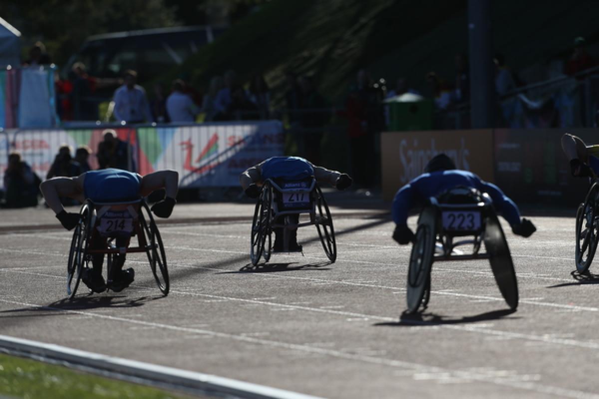 Wheelchair athletes Swansea 2014 Wheelchair athletes race on a track, photographed from the back