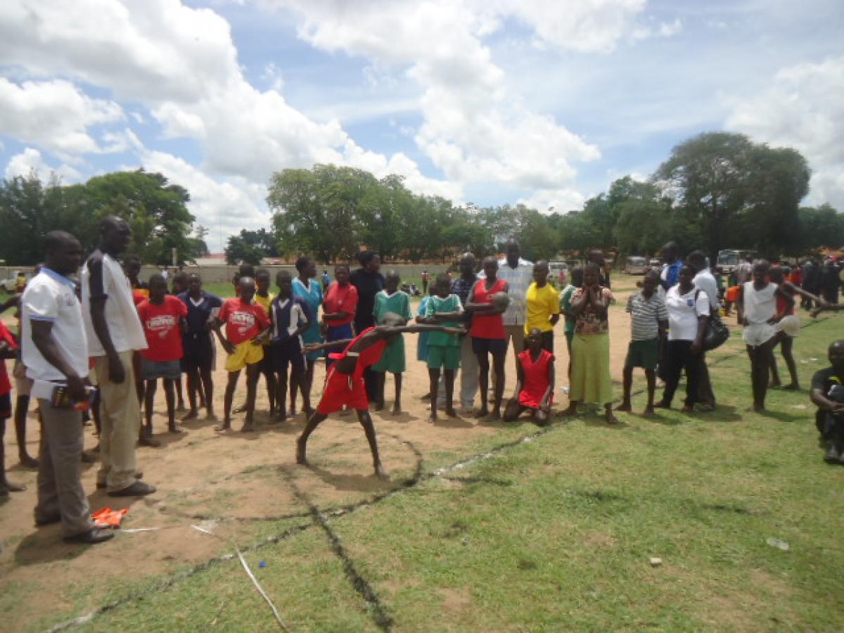 A young Ugandan tries out shot-put