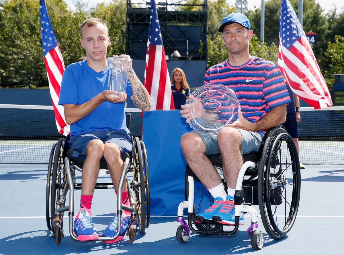 Great Britain's Andy Lapthorne (L) celebrates with the 2014 US Open trophy after defeating the USA's David Wagner (R) during the men's wheelchair quad singles final.