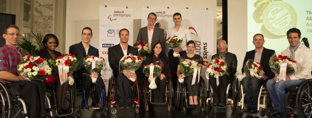 athletes holding flowers facing the camera