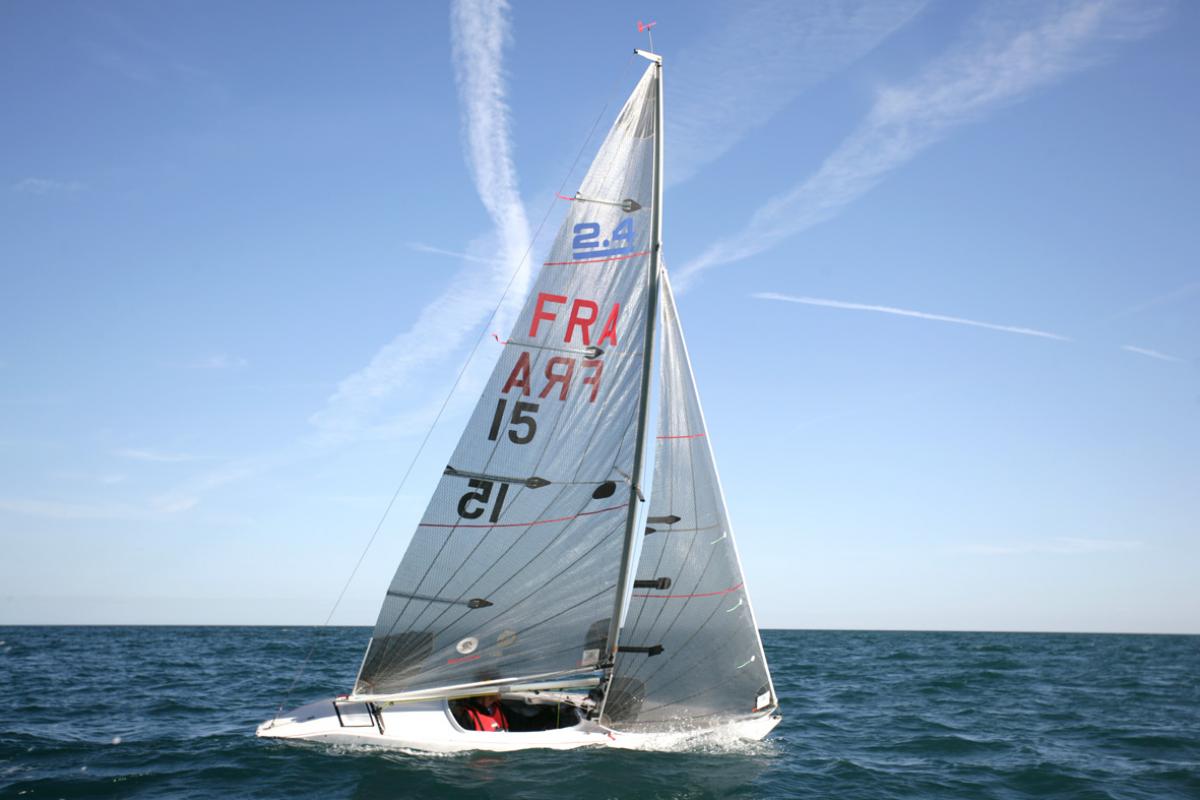 Bruno Jourden EUROSAF Sailing European Championships Man inside sailing boat with FRA and 15 written on the sail