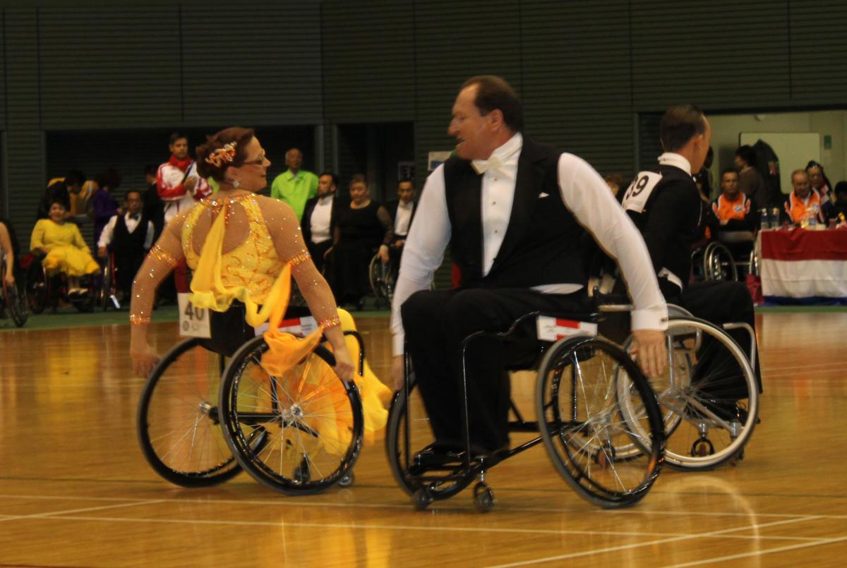 Two dancers in wheelchairs posing during a performance