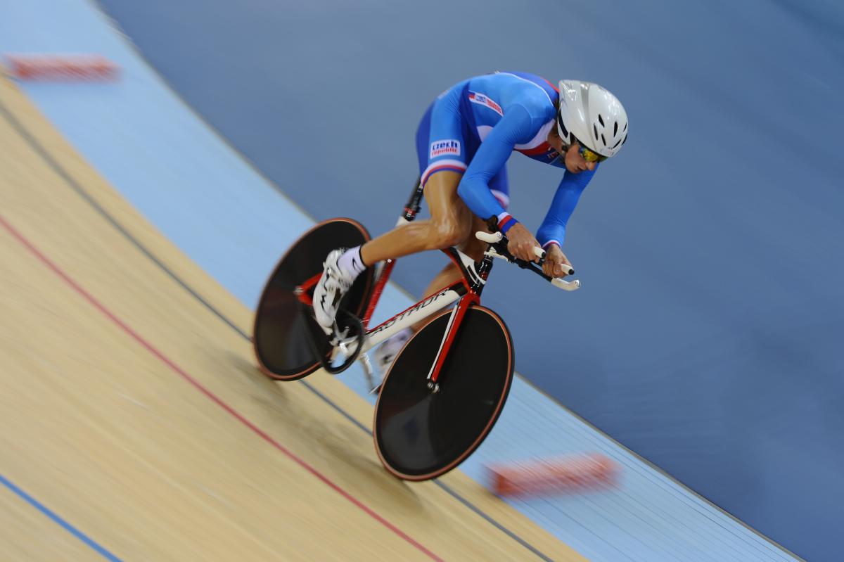 Man on a bike in racing suit, racing on a track