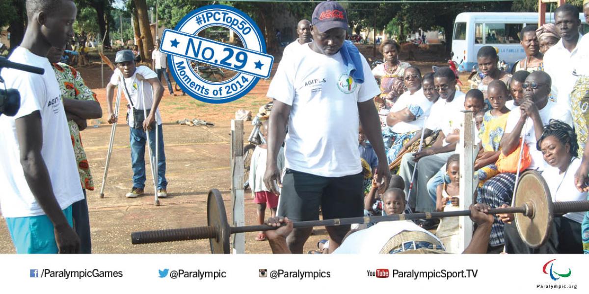 No. 29 Agitos Foundation grows Paralympic Movement globally Man on bench press with other people standing around him, watching him.