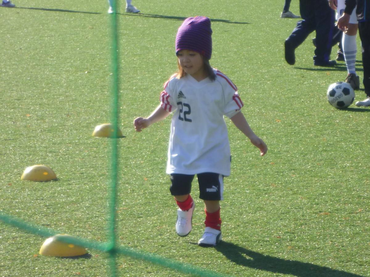 Little girls plays with football