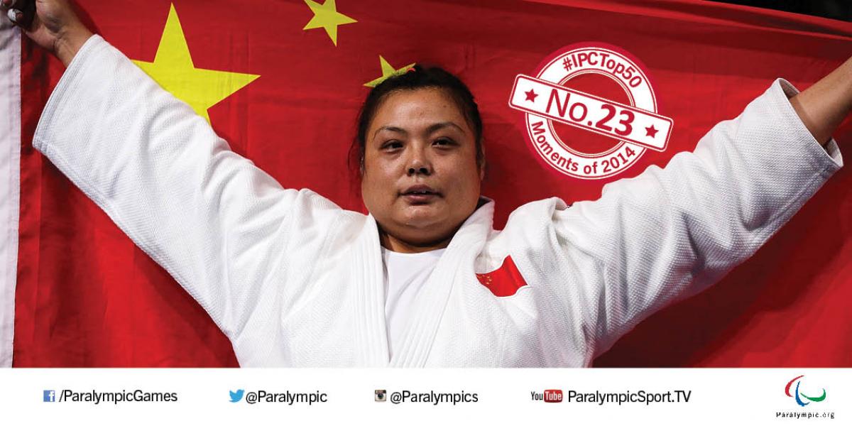 No. 23 Yanping adds world judo title to Paralympic success Women in white clothes holds a Chinese flag