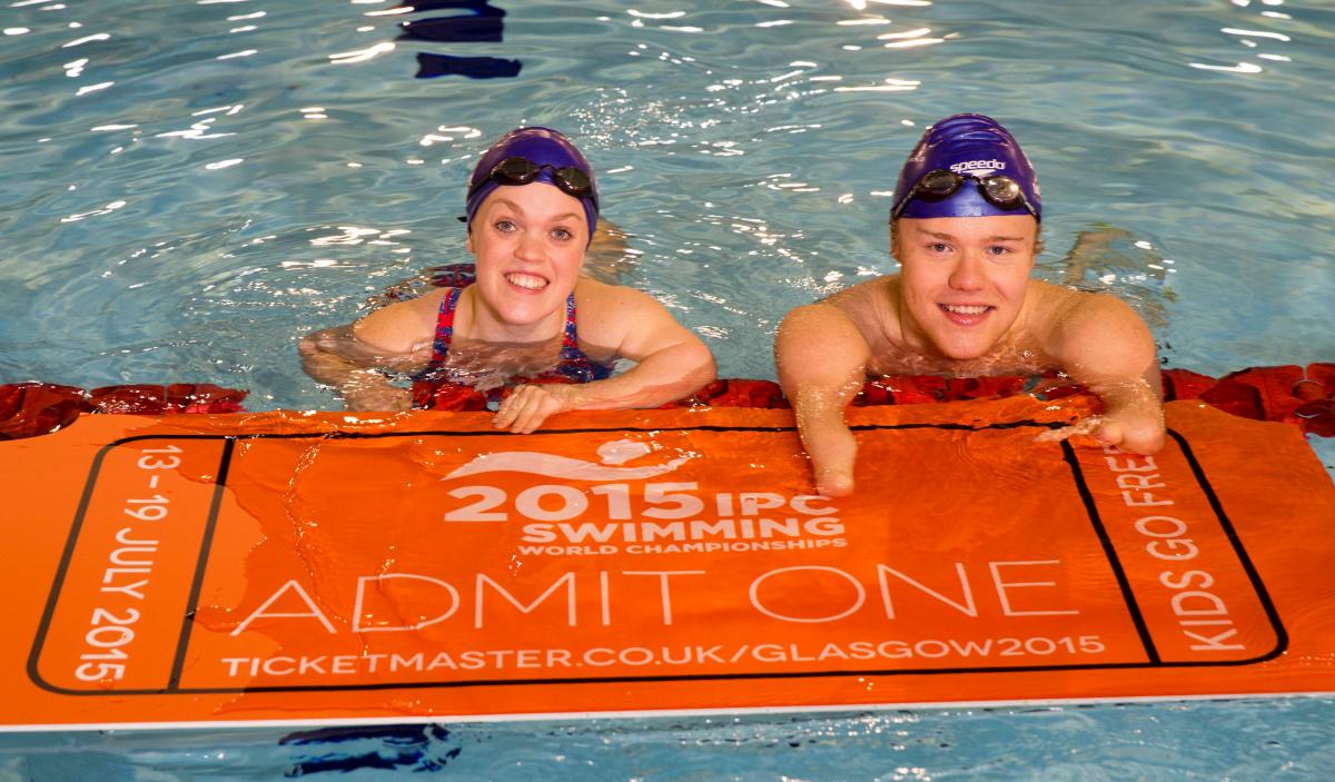 Ellie Simmonds and Andrew Mullen in the pool with a huge ticket in hand