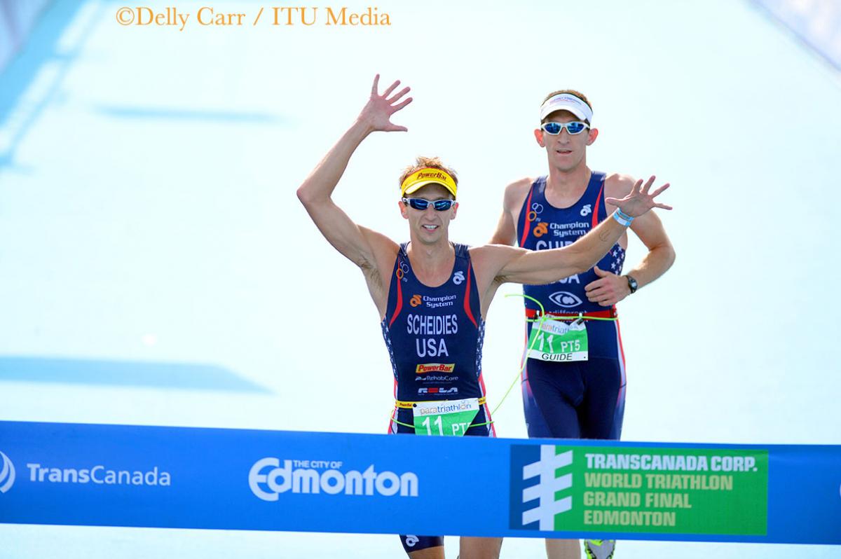 Aaron Scheidies crosses the finish line with his guide at a race in Edmonton.