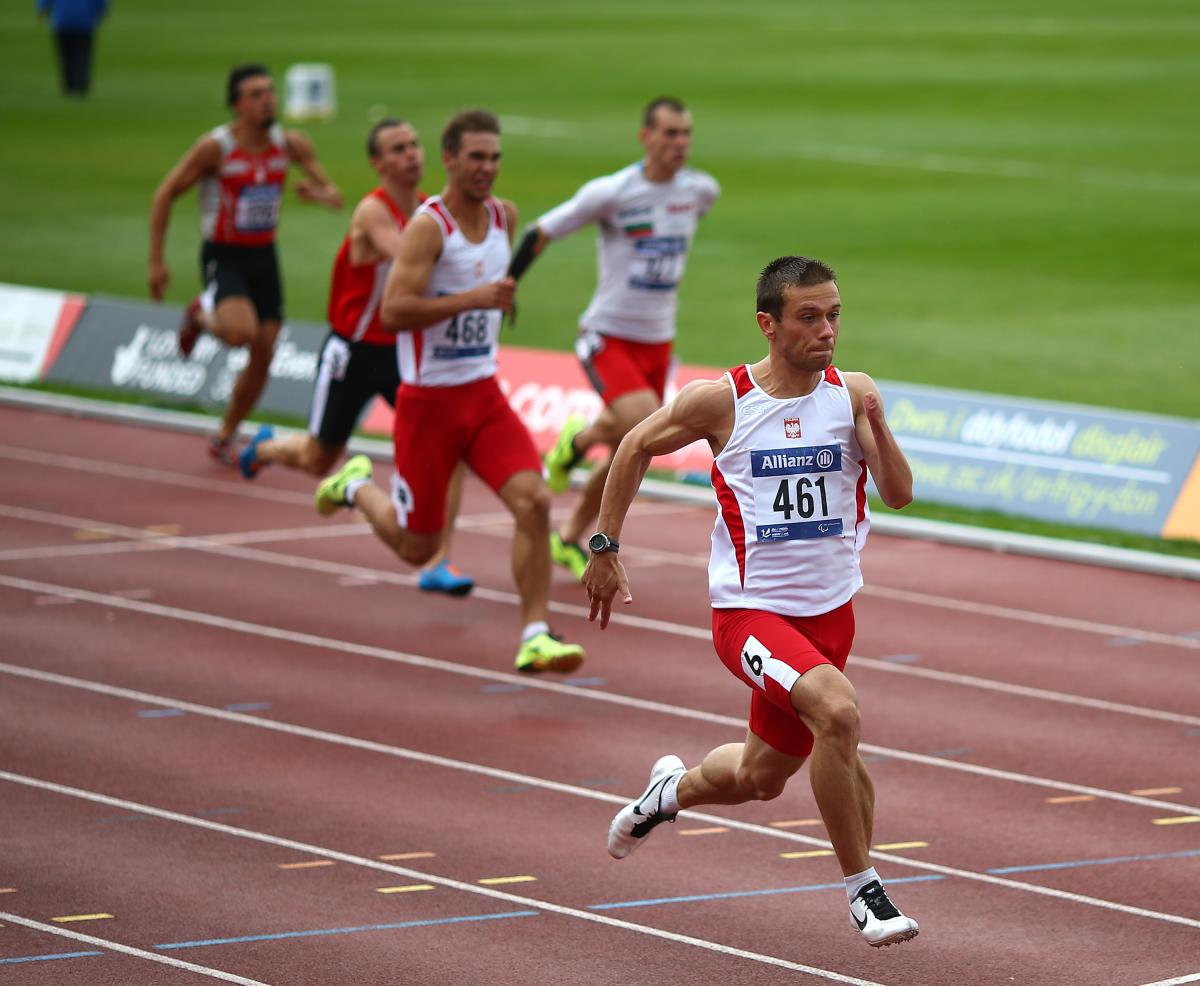 Group of men sprinting on a track