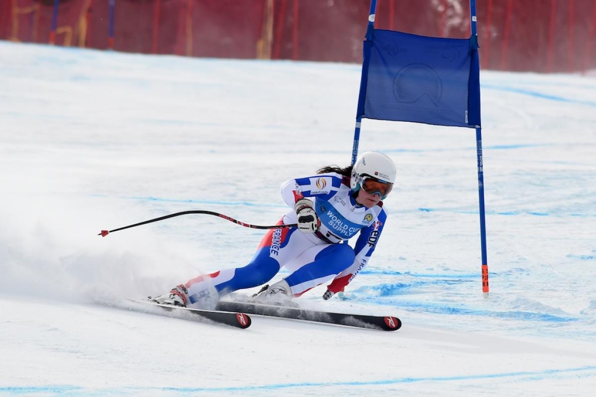 A female standing skier competes in super-G