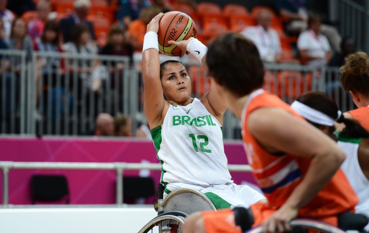 women in wheelchair saves the basketball