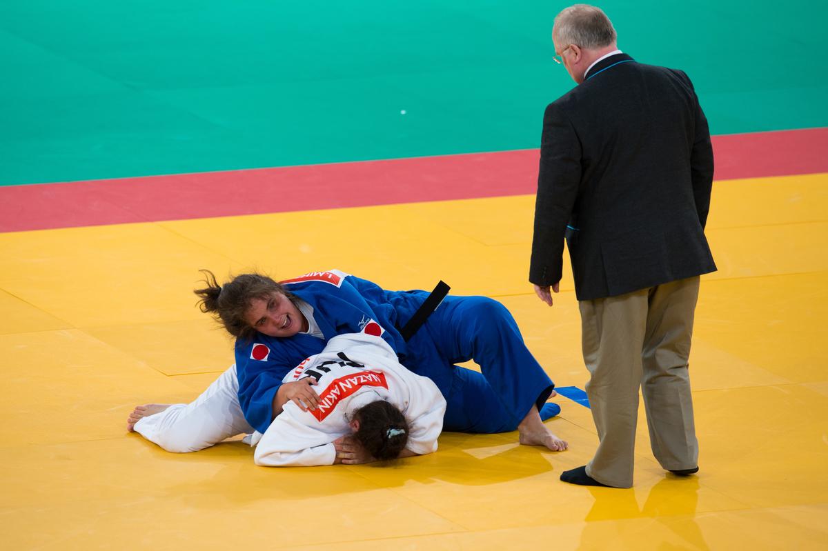 Two women on the floor, practising judo