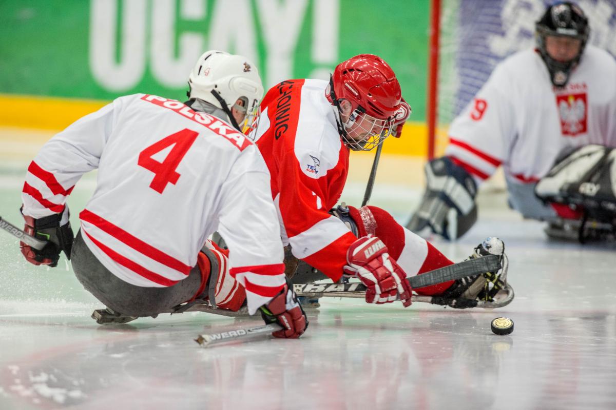 Sylwester Flis, Poland, and Martin Pachoinig, Austria, fighting for the puck in the preliminary game at the 2015 IPC Ice Sledge Hockey World Championships B-Pool in Ostersund, Sweden.