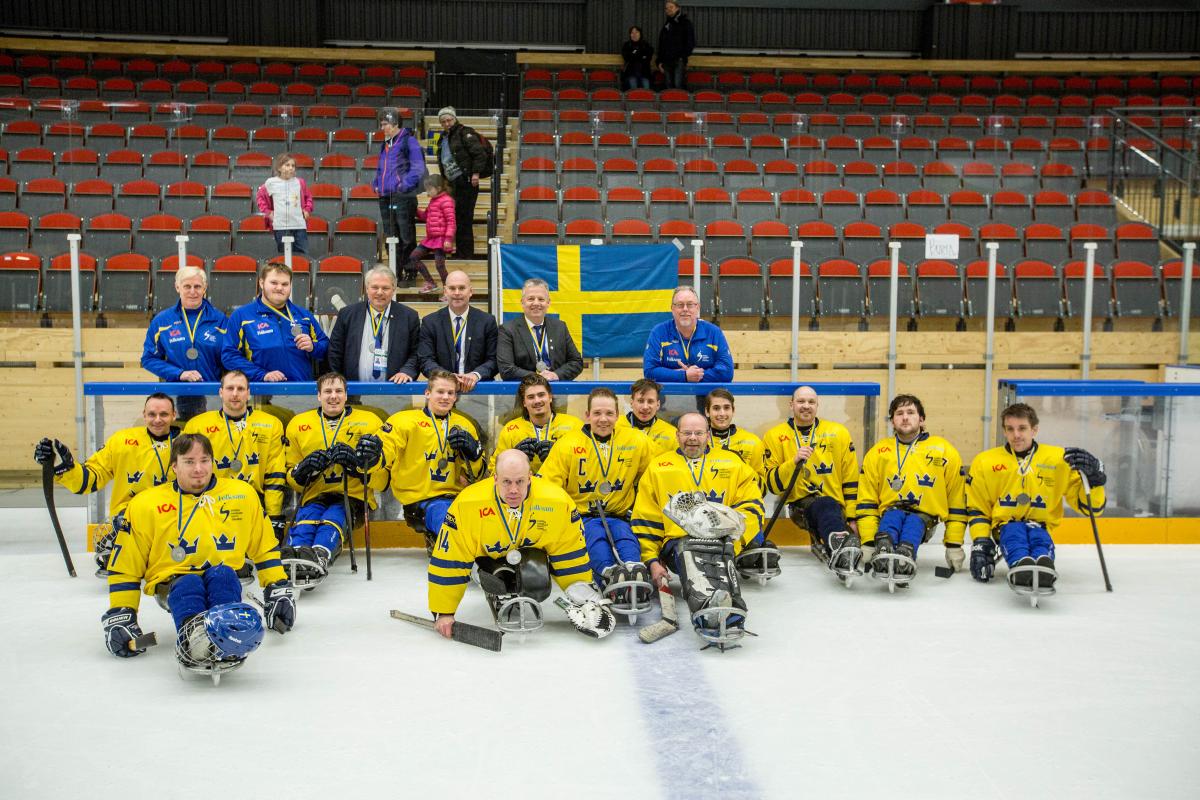 Sweden - victory ceremony - 2015 IPC Ice Sledge Hockey World Championships B-Pool a group of Para ice hockey players on the ice with their medals