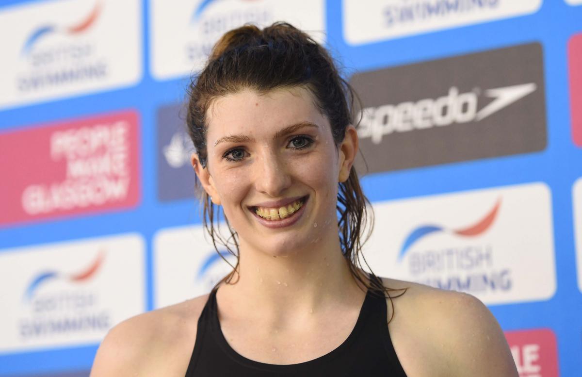 Bethany Firth head shot A swimmer smiles having won gold and set a new world record