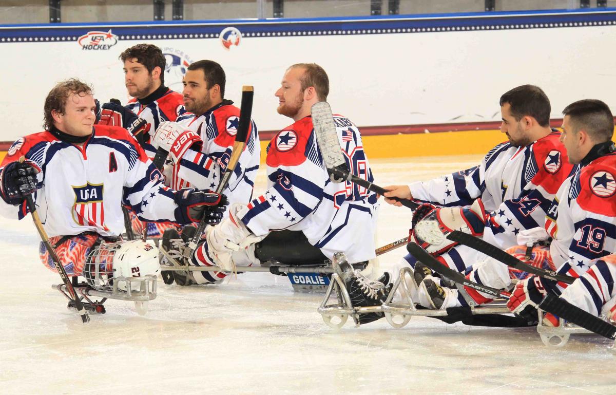 Joshua Pauls - USA v GER - 2015 IPC Ice Sledge Hockey World Championships Group of ice sledge hockey players on the ice