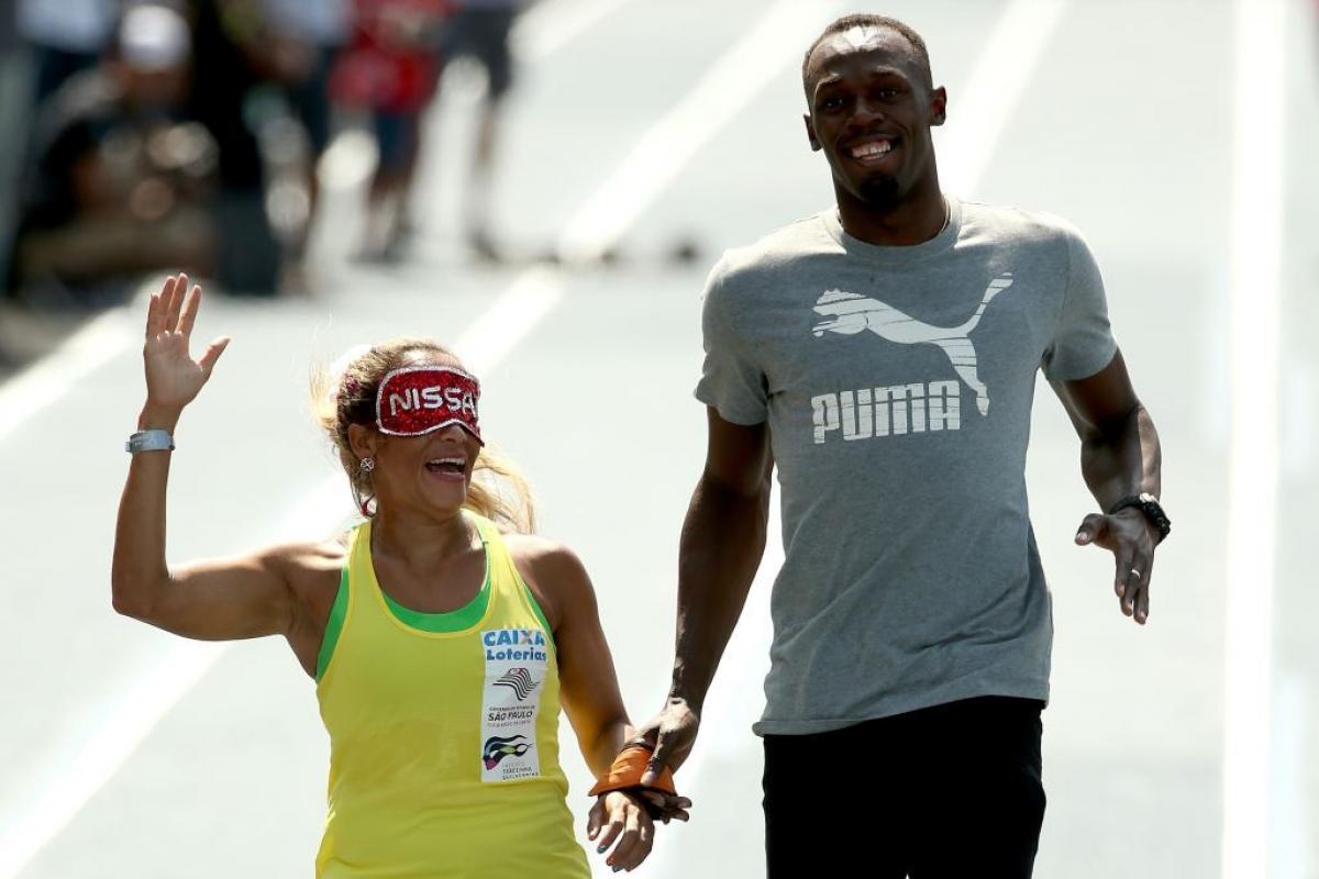 Paralympian Terezinha Guilhermina of Brazil runs with Usain Bolt of Jamaica as her guide during an exhibition in preparation for the Mano a Mano Athletics Challenge in Rio de Janeiro, Brazil. In 2011, she was elected to the APC Executive Committee at the Guadalajara Parapan American Games.