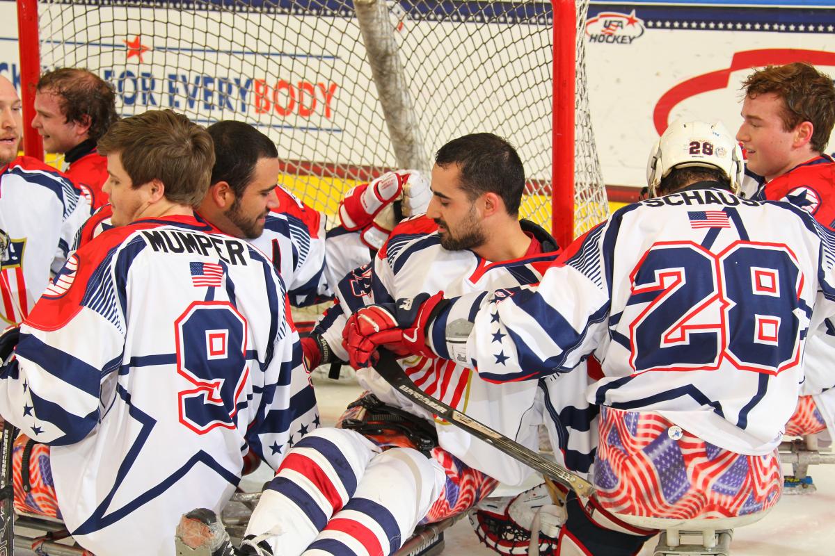 Team USA - USA v Canada - 2015 IPC Ice Sledge Hockey World Championships A-Pool Group of sledge hockey players celebrating on the ice
