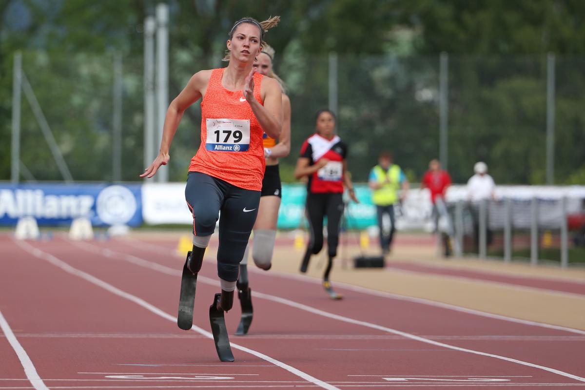 A blade runner crossers the finish line ahead of her rivals.