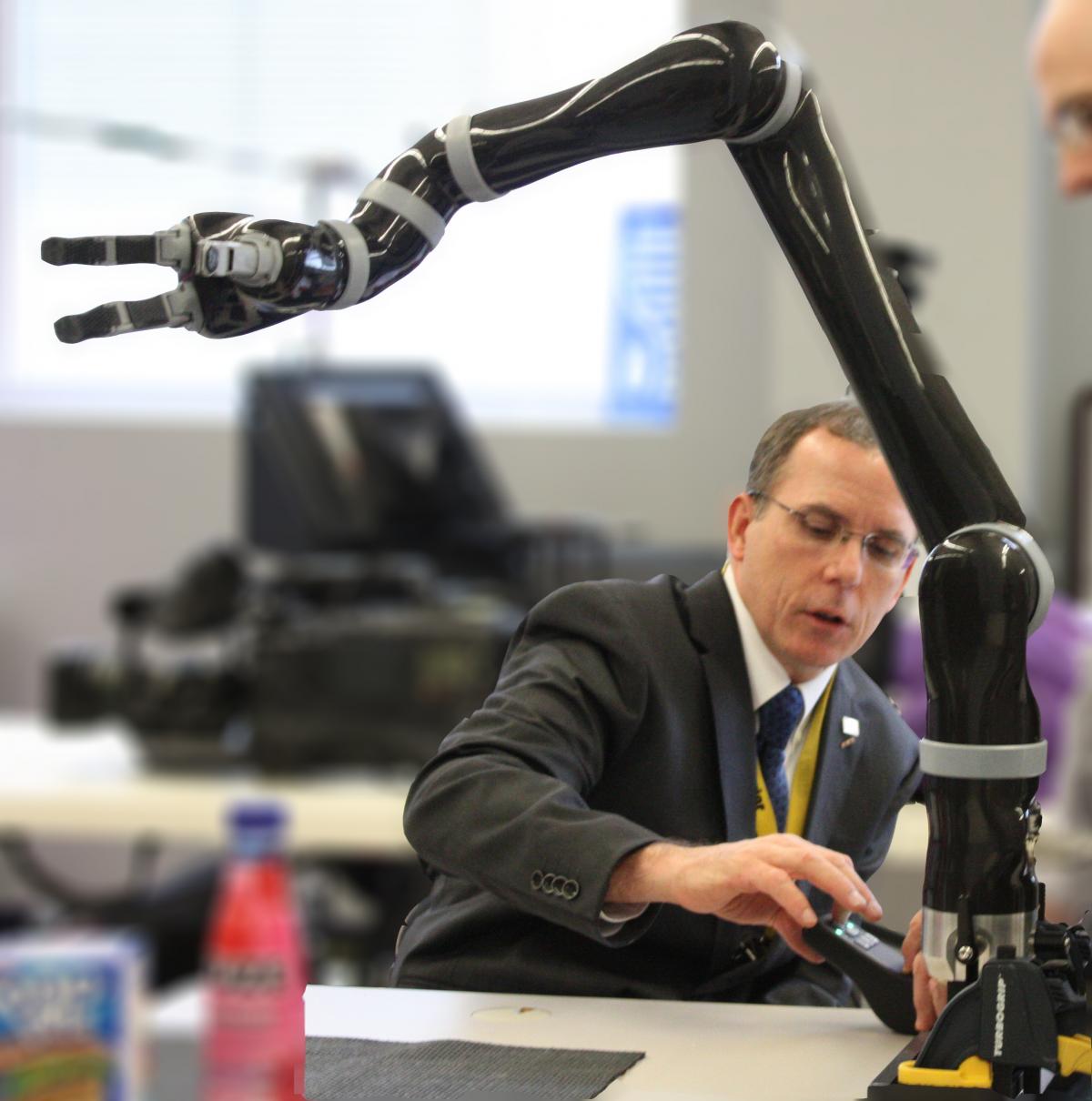Dr. Rory Cooper Paralympic Scientific Award 2013 Man working with a robot arm