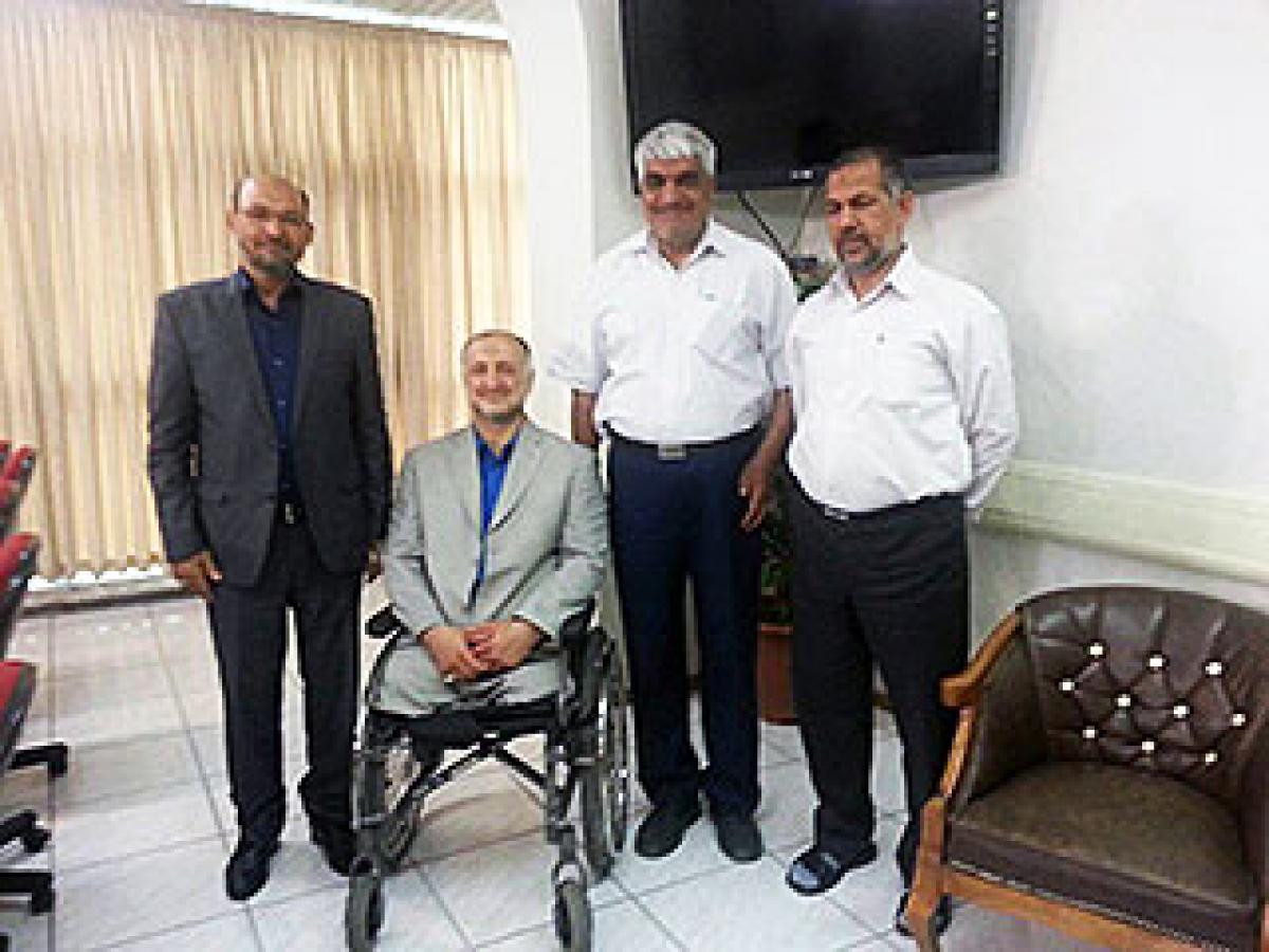 Four men pose together inside an office. 