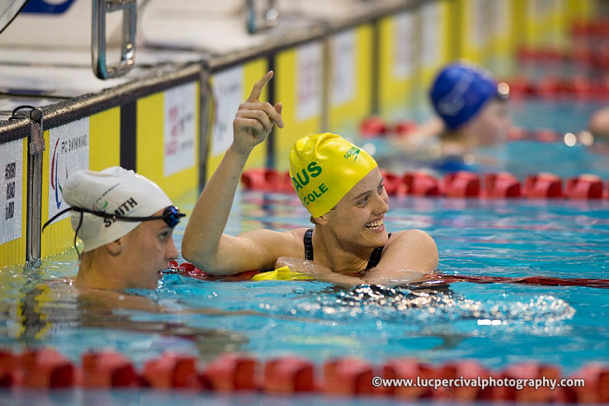 A swimmer celebrates a race win and world record