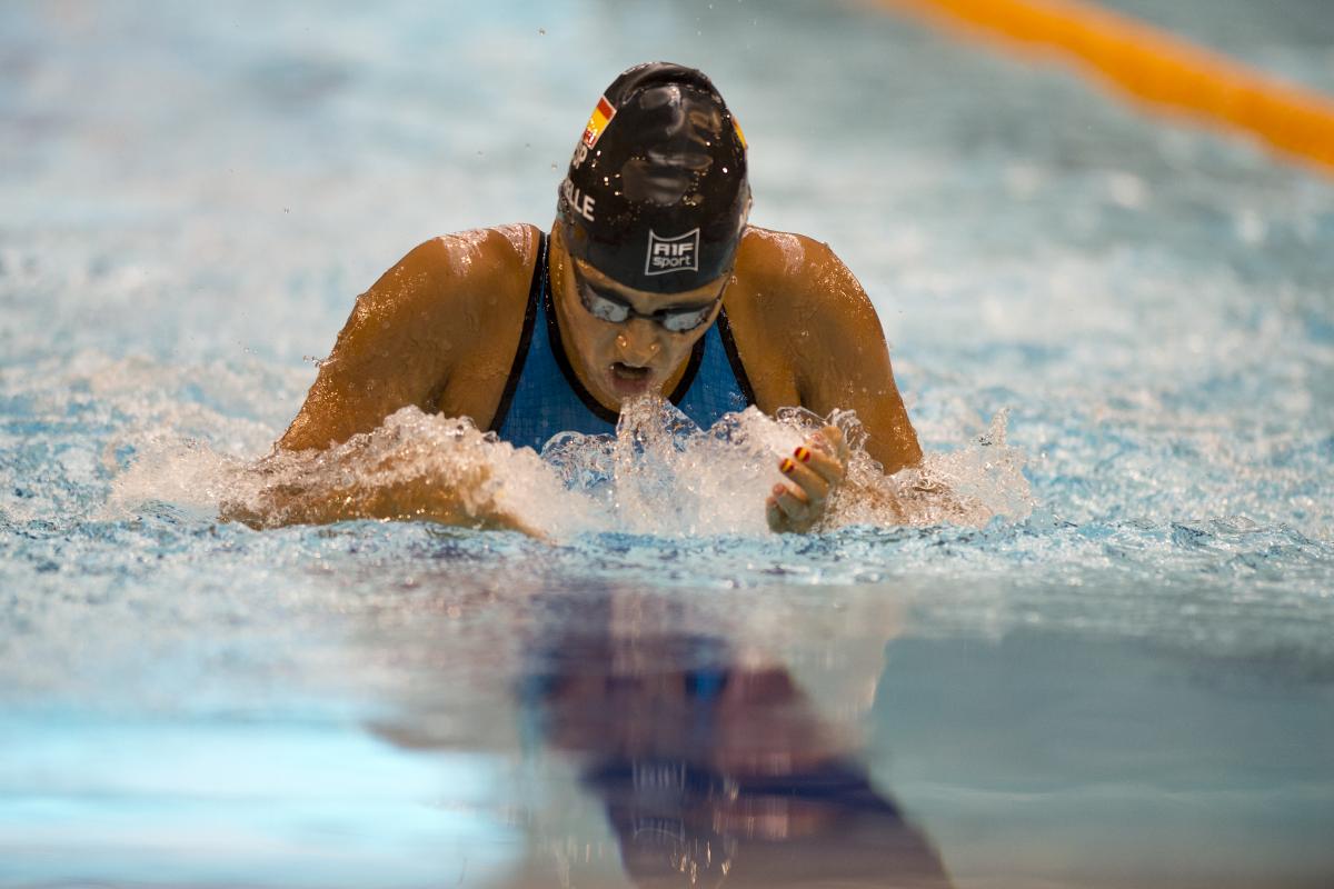 A swimmer competes in the breaststroke