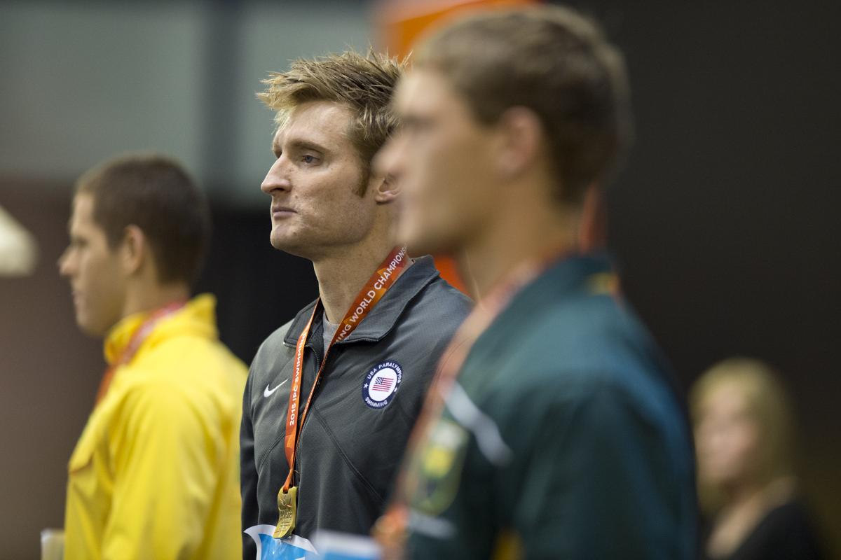 Three men on a podium