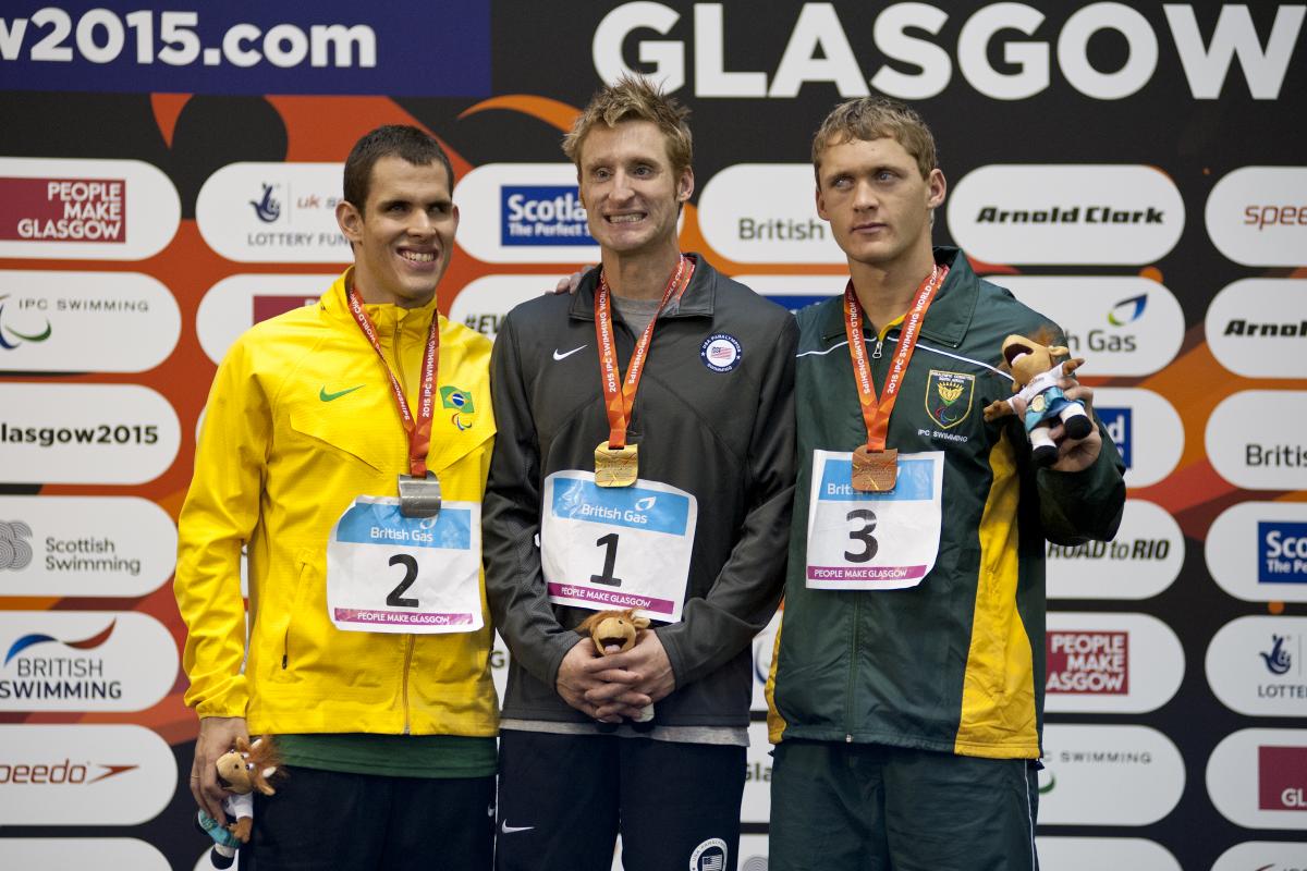 Bradley Snyder, Matheus Sousa and Hendri Herbst on the podium after the Men's 100m Freestyle S11 at the 2015 IPC Swimming World Championships in Glasgow.