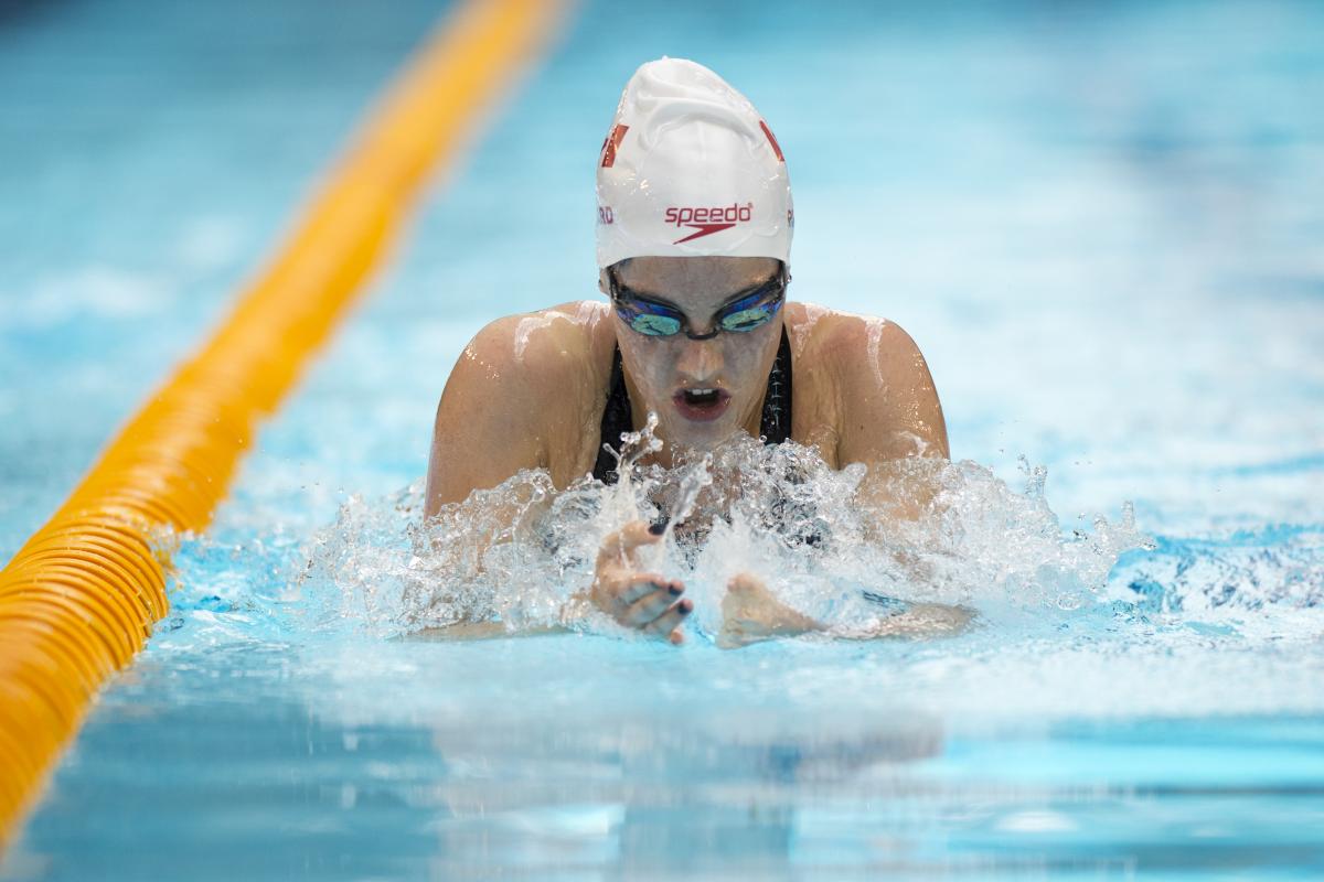 Woman in the pool swimming breaststroke