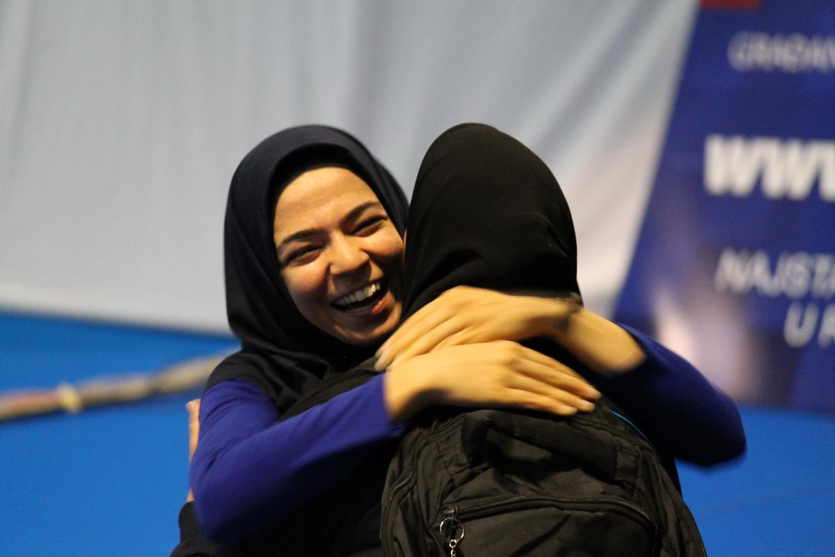 Two smiling women hugging