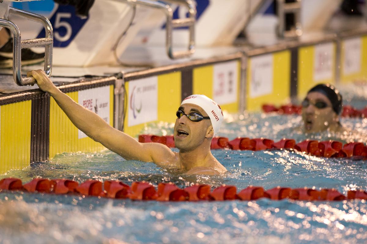 Two men in a swimming pool, after a race