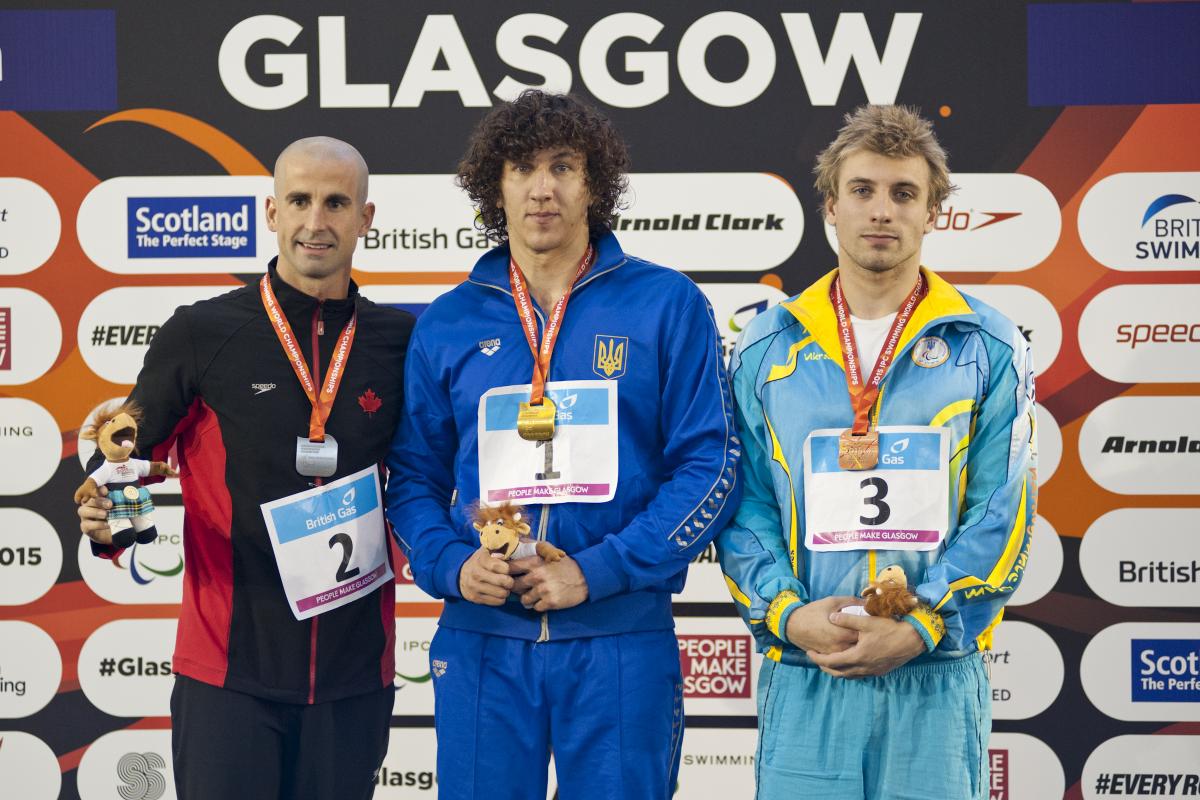 Three men on a podium