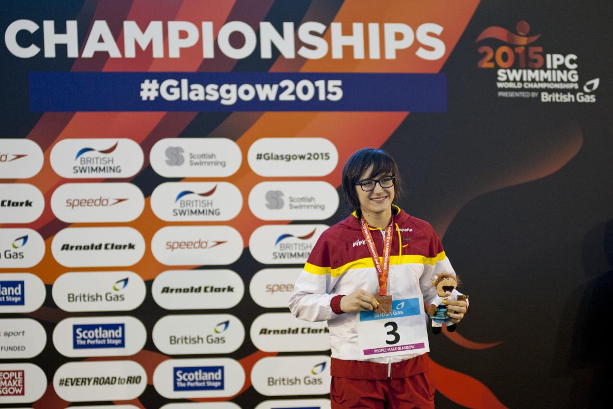 Maria Delgado Nadal of Spain on the podium after the women's 100m backstroke S12 at the 2015 IPC Swimming World Championships in Glasgow.