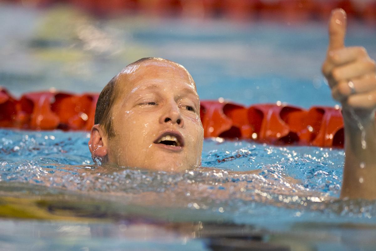 A swimmer celebrates winning a medal