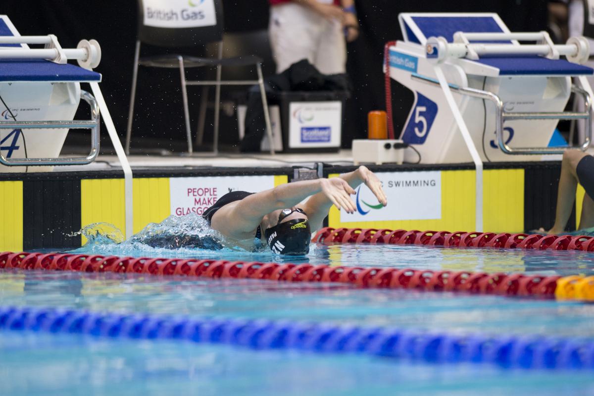 Swimmer makes a backstroke start.