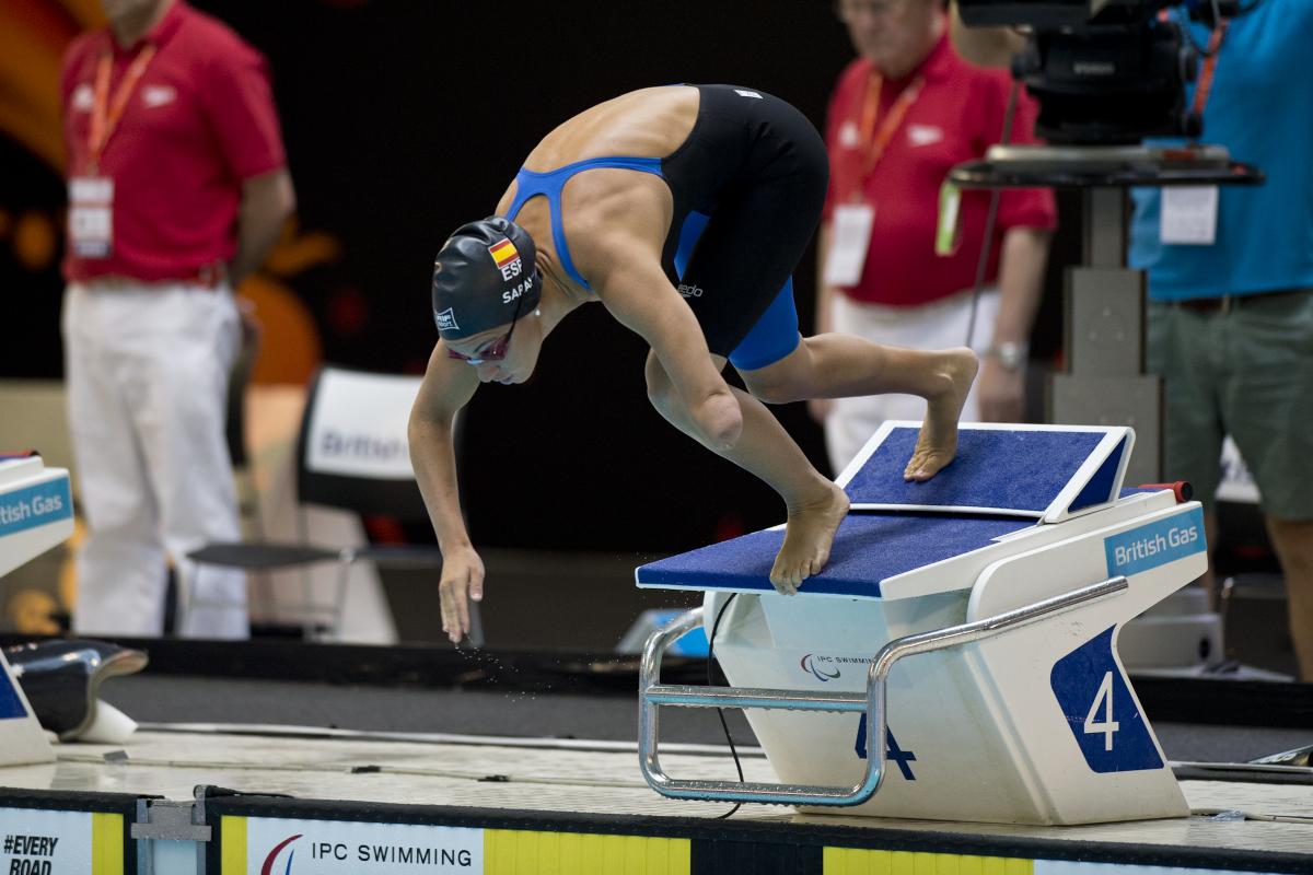 A swimmer starts their race