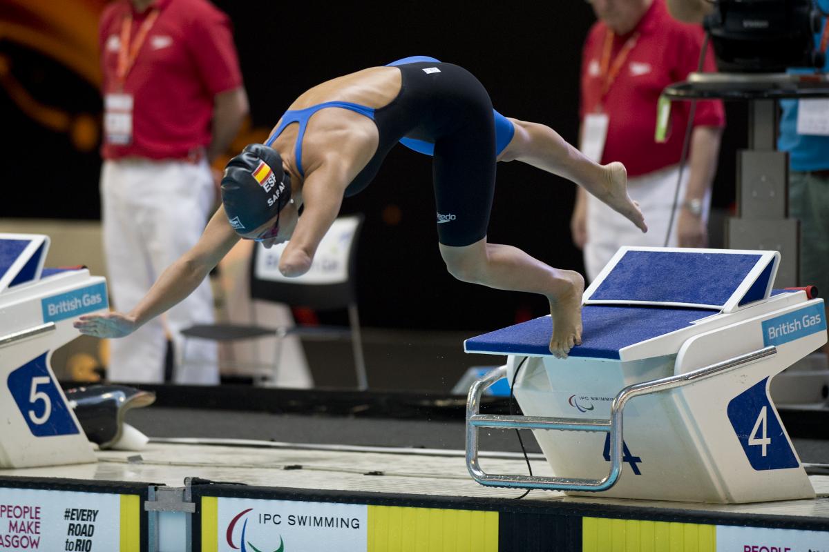 A swimmer launches off of the starting blocks