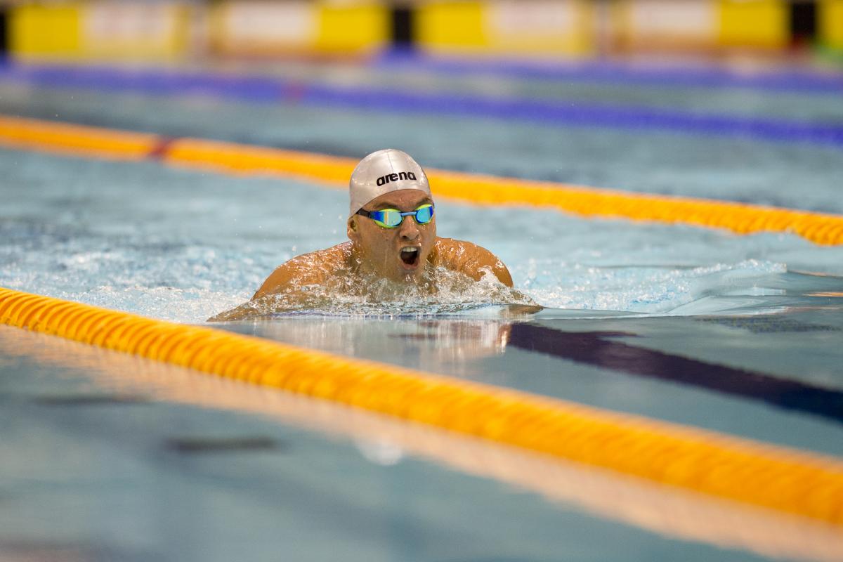 Man in a pool doing breast stroke