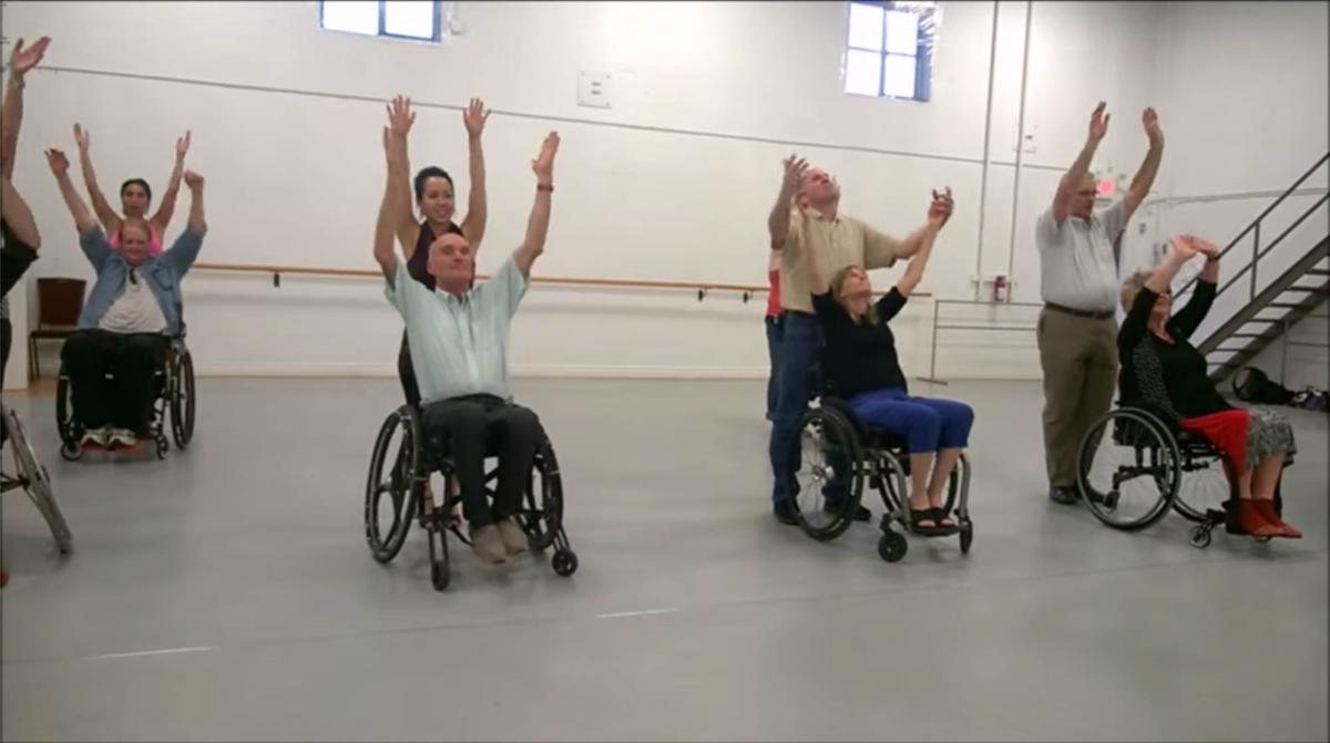 Wheel Dance Group of people in wheelchairs and standing dancing