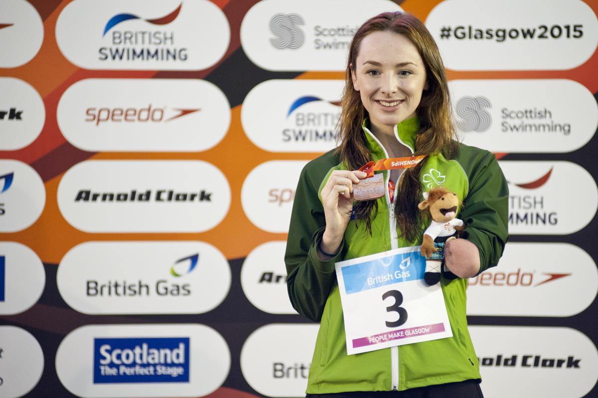 A para-swimmer celebrates winning a medal