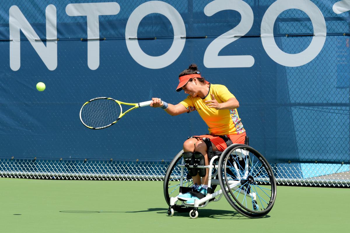 Wheelchair tennis player hitting a ball