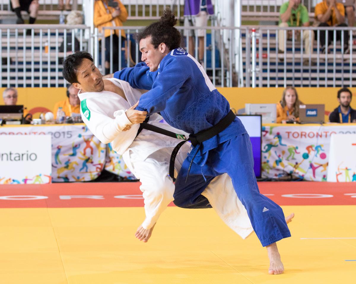 Luis Perez Diaz of Puerto Rico, fighting against Robert Kim of USA in the men's -66kg judo at the Toronto 2015 Parapan American Games.