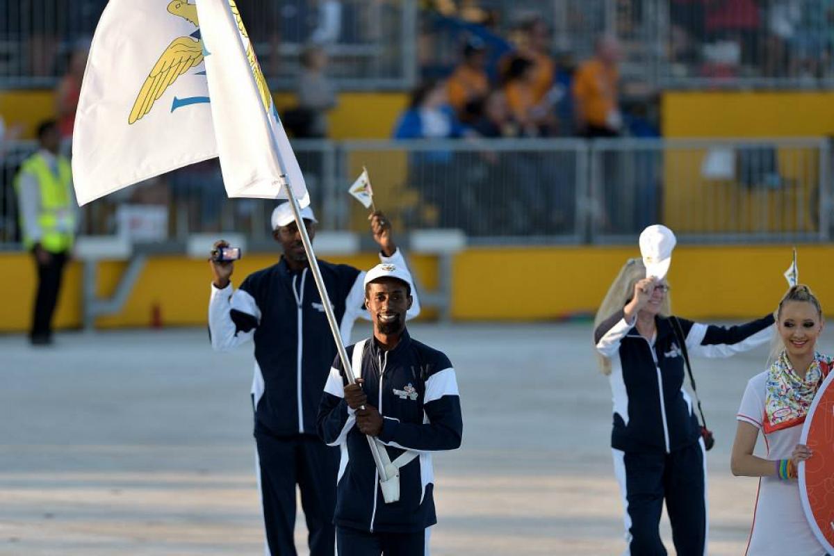 Ivan Espinosa - US Virgin Islands - Toronto 2015 Man in a staduim, waving a flag followed by two other people