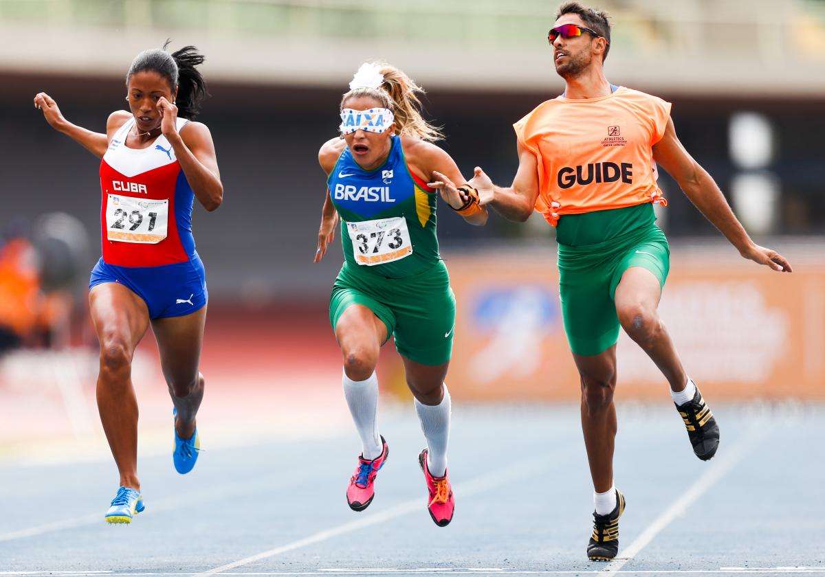 Omara Durand and Terezinha Guilhermina at 2015 IPC Grand Prix in Sao Paulo blindfolded runner with guide and another female runner crossing a finish line
